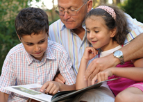 Photo of a grandfather reading to his grandchildren. Link to Life Stage Gift Planner Over Age 70 Gifts. Photo of a grandfather reading to his grandchildren. Link to Life Stage Gift Planner Over Age 70 Gifts.